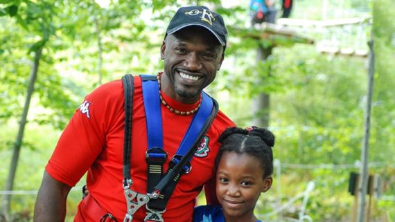 Father and daughter smiling at park