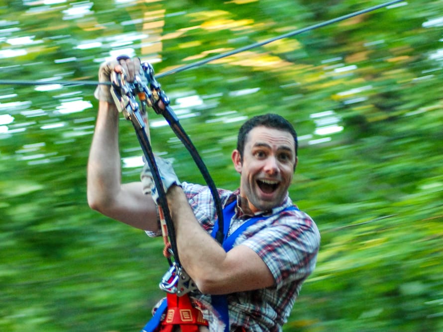 Adult man zip lining
