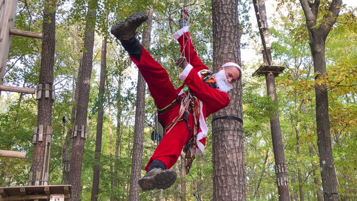 man dressed as santa while ziplining