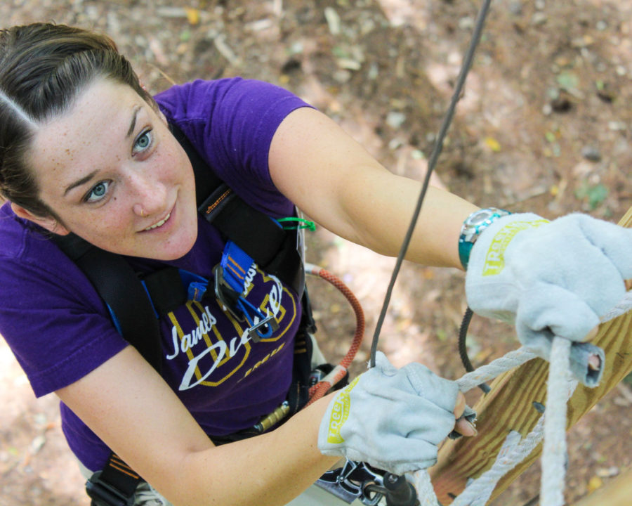 Woman climbing rope ladder