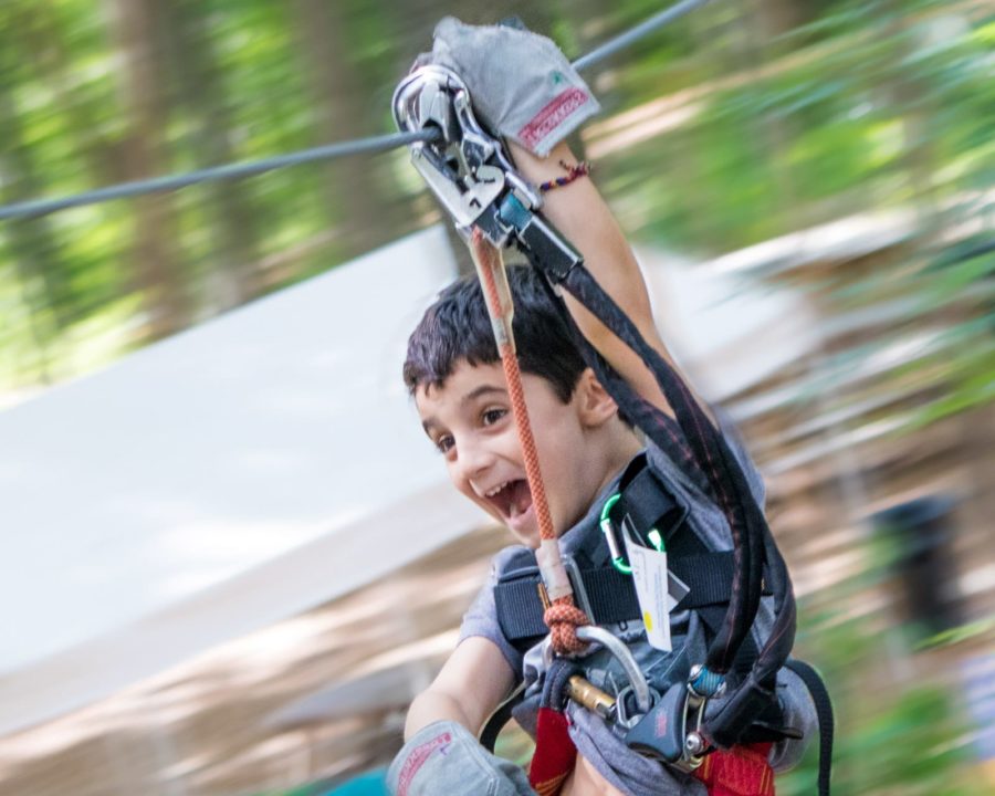 Young boy zip lining